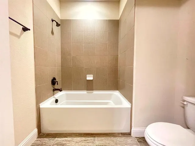 a bathroom with a bathtub and shower