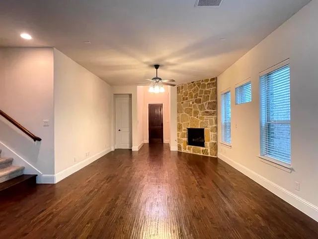 wooden floor in an empty room with a fireplace