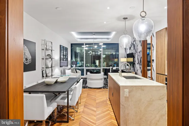 a view of a dining room with furniture and chandelier