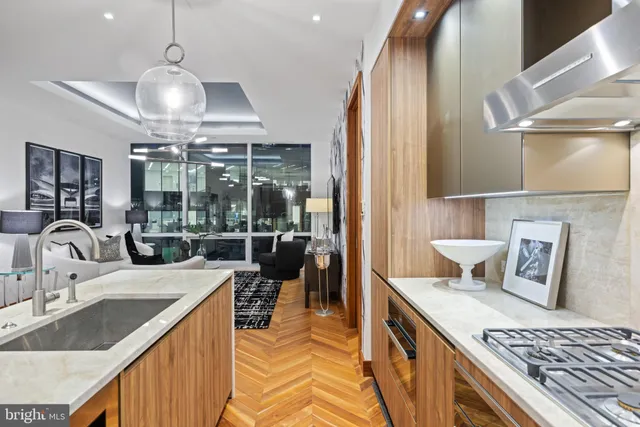 a kitchen with kitchen island granite countertop a sink stove and cabinets