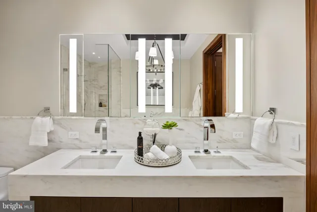 a bathroom with a double vanity sink and mirror