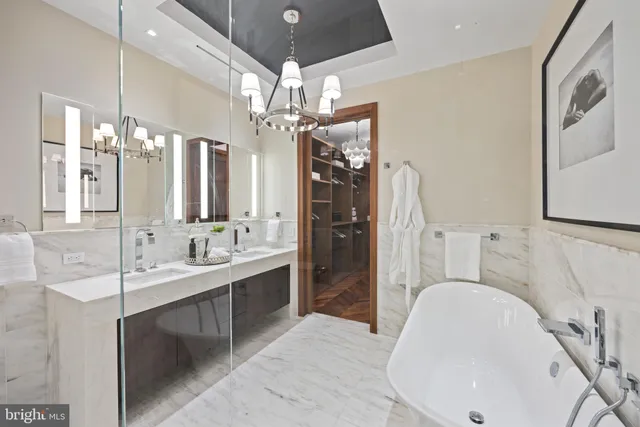 a spacious bathroom with a sink a large mirror and a shower