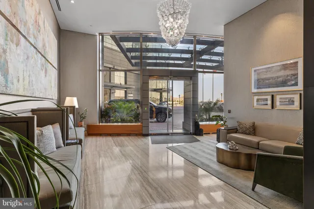 a living room with furniture and a chandelier