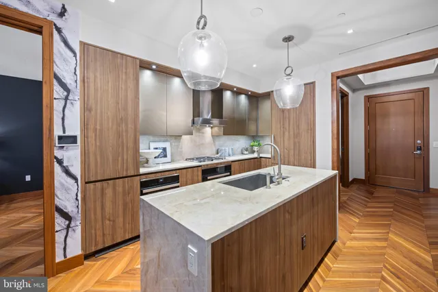 a kitchen with a refrigerator a sink and a cabinets