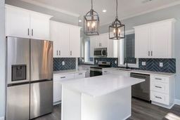 a kitchen with stainless steel appliances a refrigerator sink and microwave