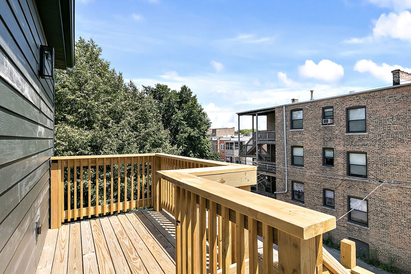 643 East 50th Street Chicago, IL 60615 - Photo 21 of 22 a view of a roof deck with wooden floor and fence