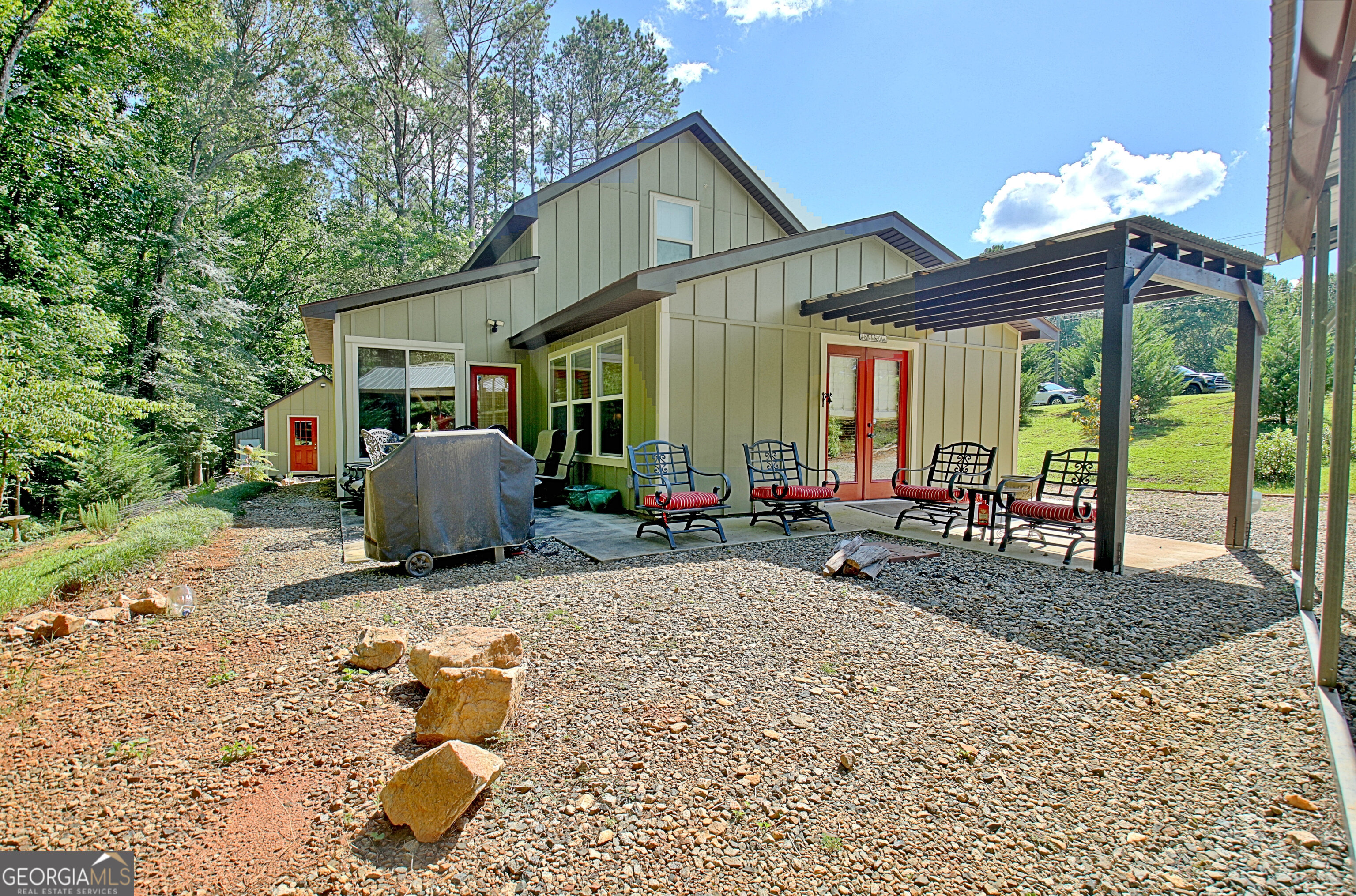 a view of a house with backyard sitting area and glass windows