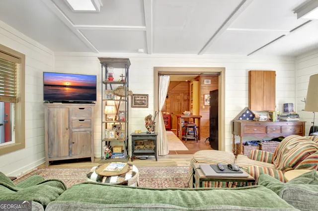 a dining room with furniture and a floor to ceiling window