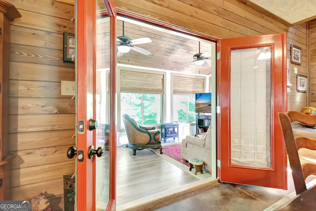 a dining room with furniture and a chandelier fan