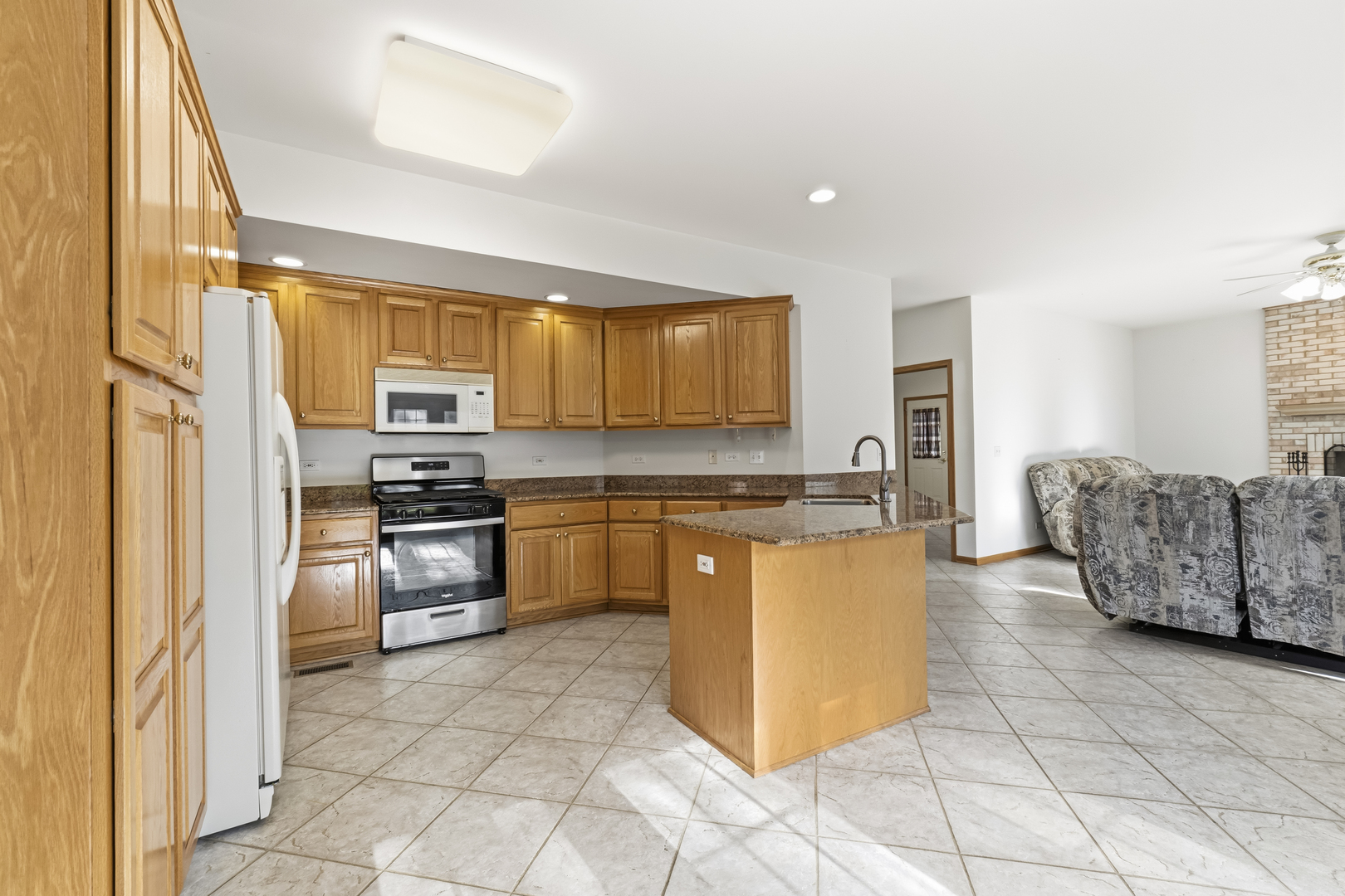 546 Fourth Avenue Addison, IL 60101 - Photo 12 of 39 a kitchen with stainless steel appliances granite countertop a refrigerator sink and stove