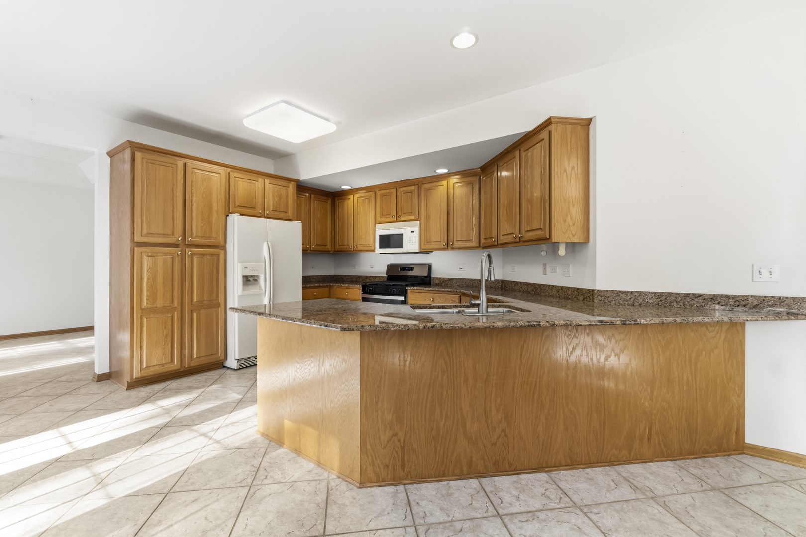 546 Fourth Avenue Addison, IL 60101 - Photo 13 of 39 a kitchen with stainless steel appliances granite countertop a refrigerator a stove and a sink with granite countertops