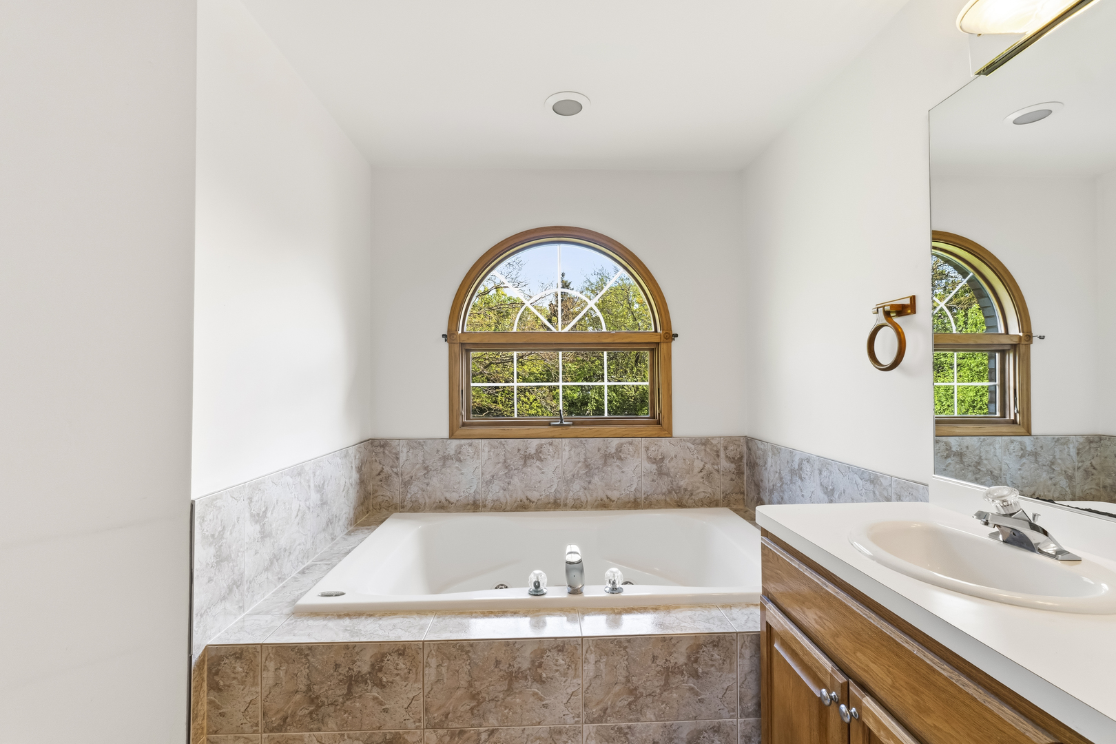 546 Fourth Avenue Addison, IL 60101 - Photo 21 of 39 a bathroom with a granite countertop bathtub a sink and a window