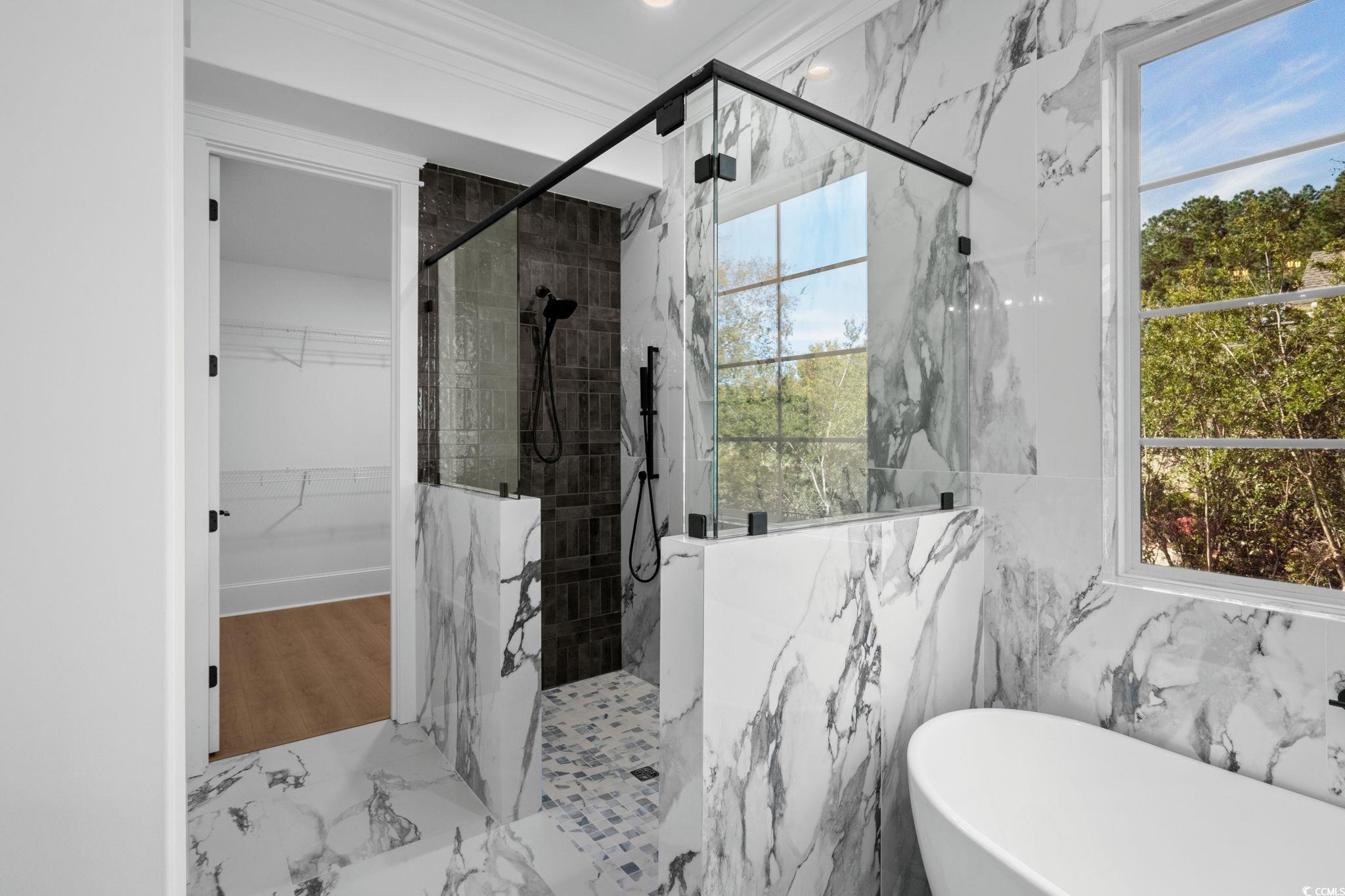9282 Checkerberry Square Calabash, NC 28467 - Photo 18 of 40 Full bathroom with a marble finish shower, a freestanding tub, marble tiled flooring, a spacious closet, and crown molding