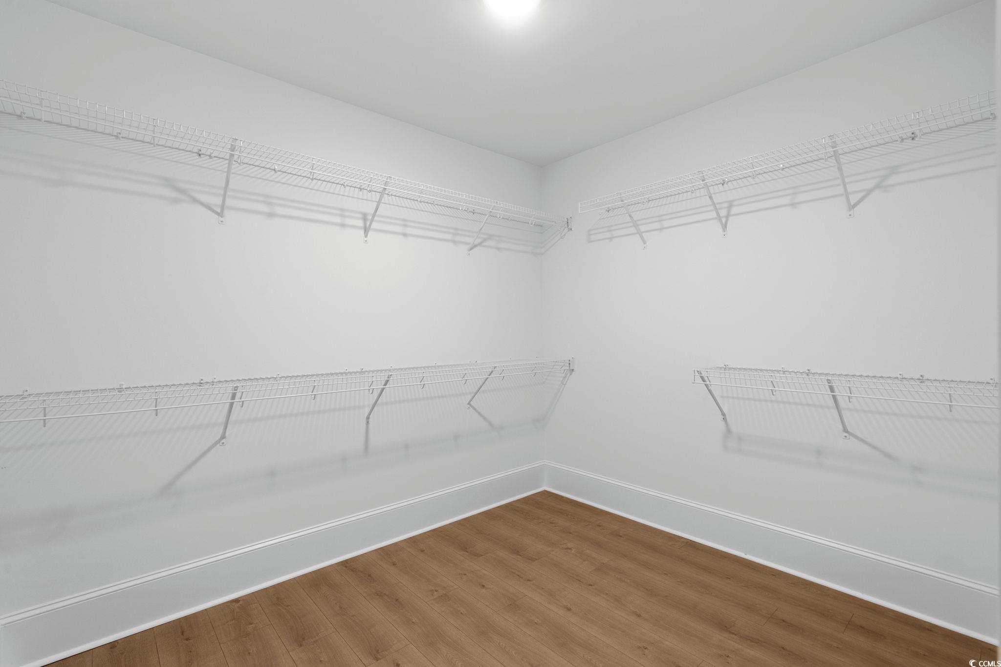 9282 Checkerberry Square Calabash, NC 28467 - Photo 19 of 40 Spacious closet with wood finished floors