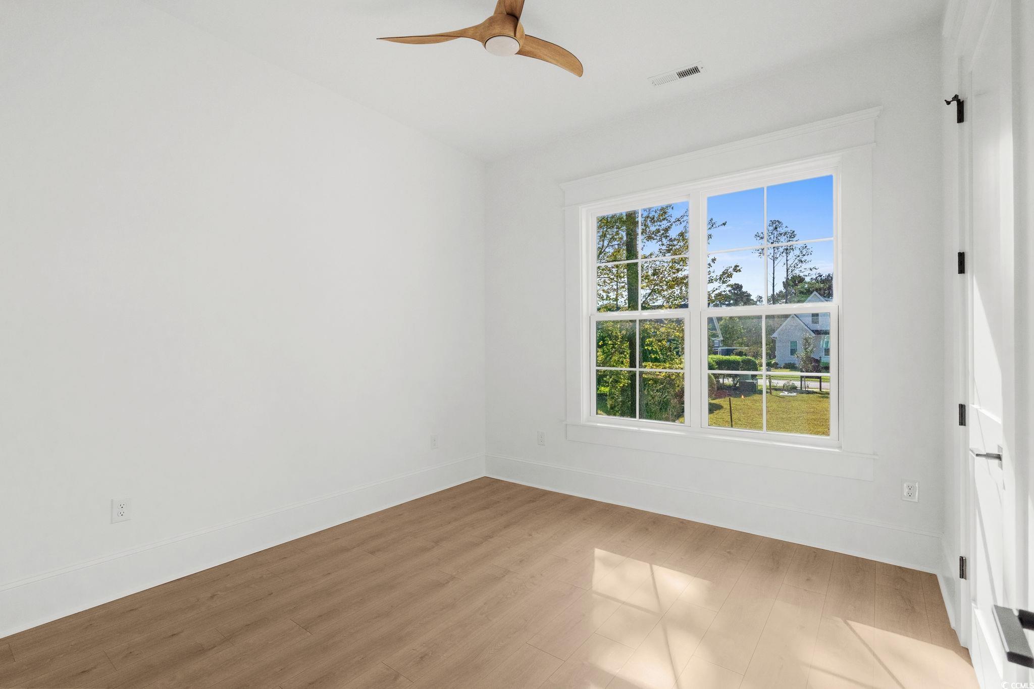 9282 Checkerberry Square Calabash, NC 28467 - Photo 20 of 40 Empty room with wood finished floors and ceiling fan