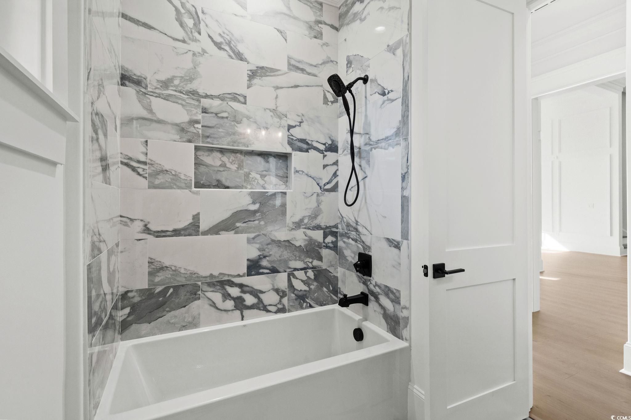 9282 Checkerberry Square Calabash, NC 28467 - Photo 22 of 40 Full bathroom featuring shower / bath combination and wood finished floors