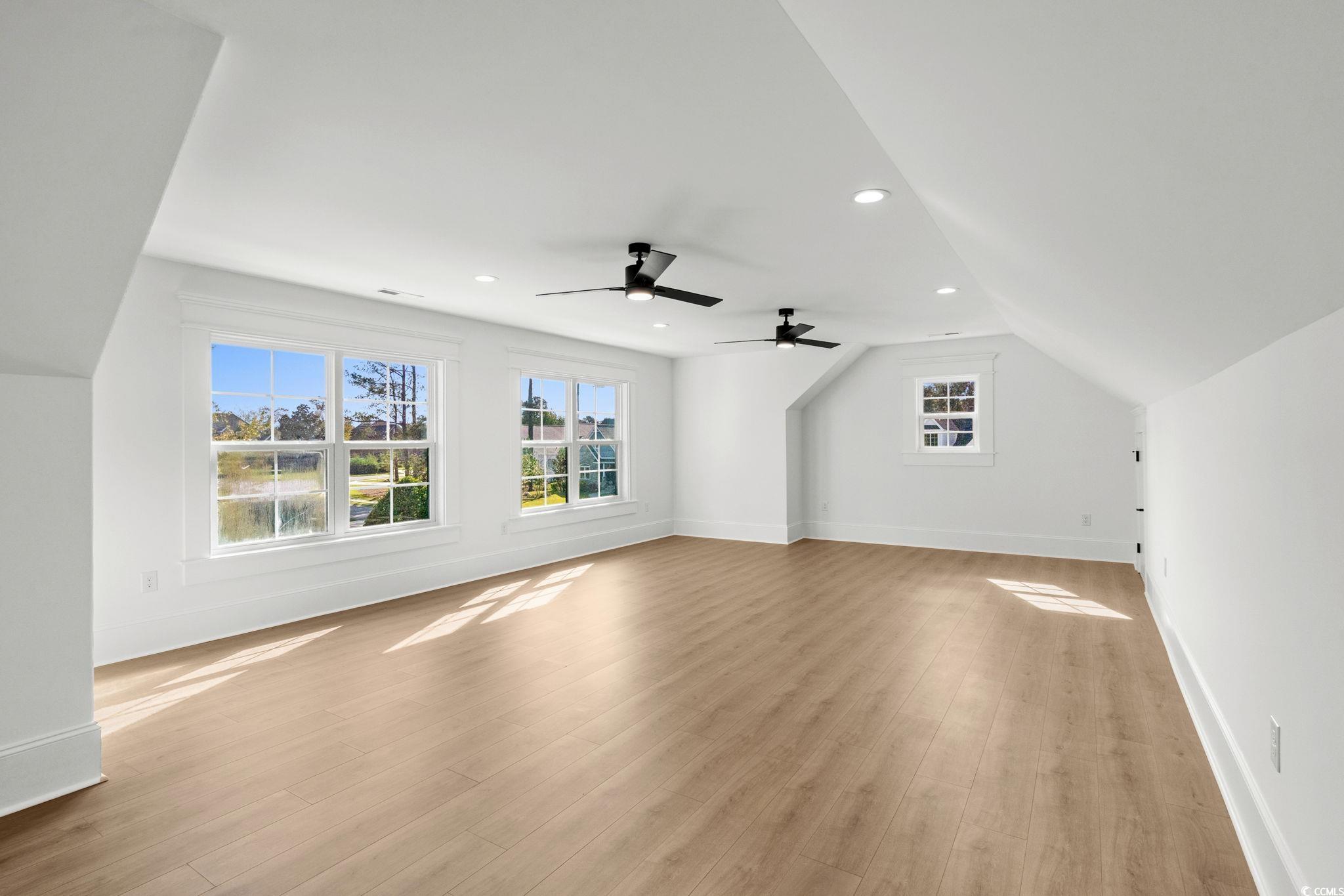 9282 Checkerberry Square Calabash, NC 28467 - Photo 23 of 40 Additional living space featuring recessed lighting, light wood-type flooring, and lofted ceiling