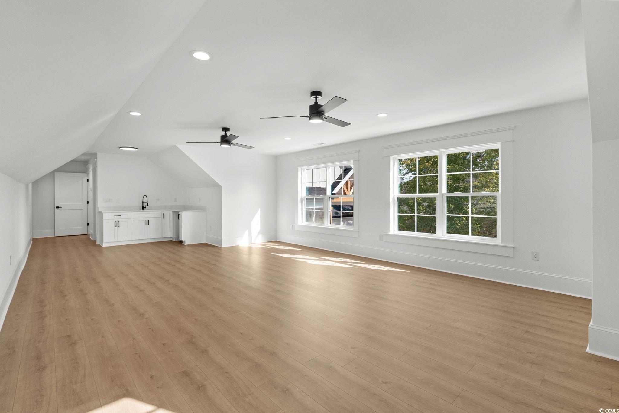 9282 Checkerberry Square Calabash, NC 28467 - Photo 24 of 40 Additional living space featuring recessed lighting, light wood finished floors, and lofted ceiling