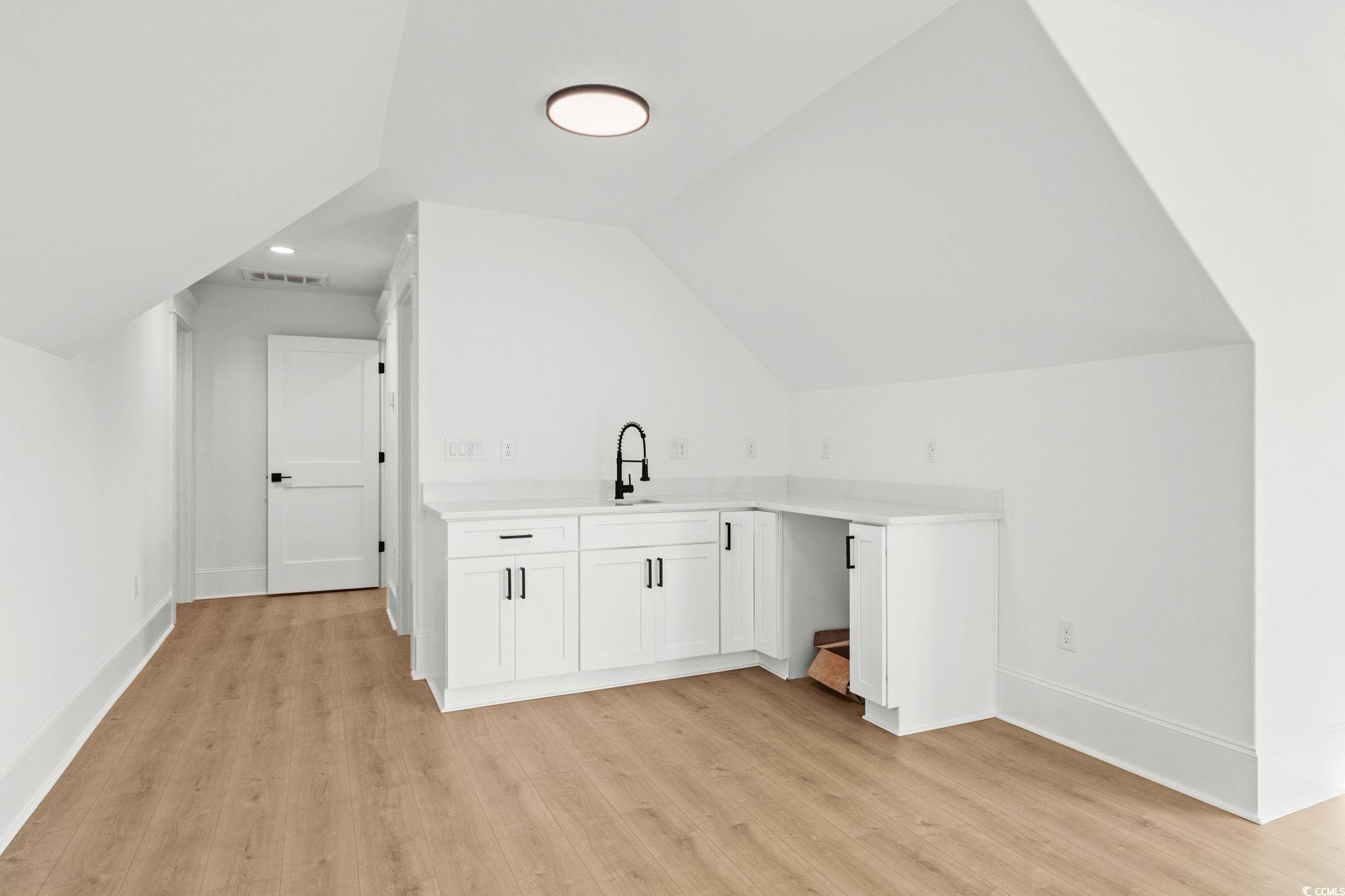 9282 Checkerberry Square Calabash, NC 28467 - Photo 25 of 40 Bonus room with light wood finished floors, vaulted ceiling, and recessed lighting