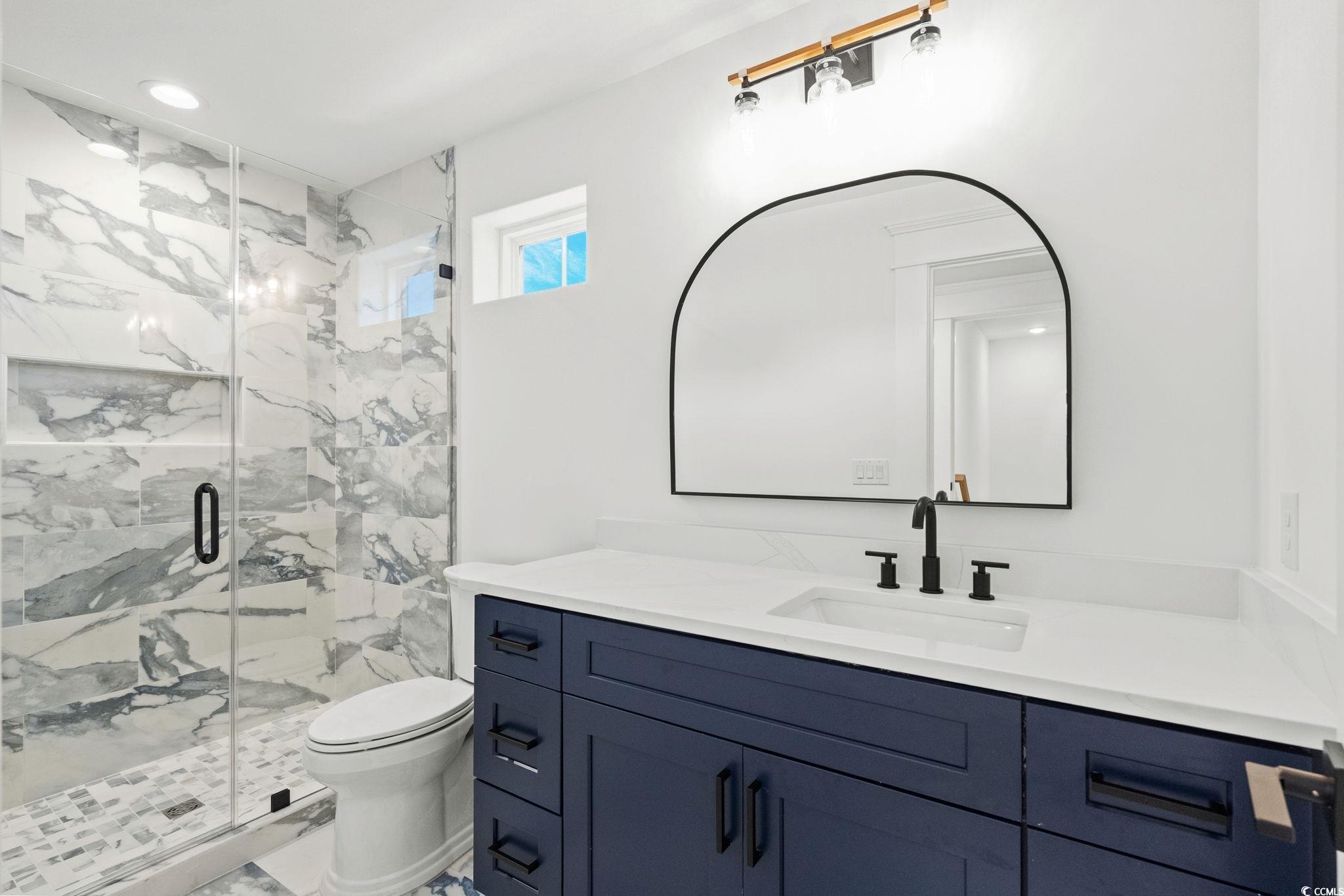 9282 Checkerberry Square Calabash, NC 28467 - Photo 26 of 40 Full bath featuring vanity, a marble finish shower, marble finish flooring, and recessed lighting