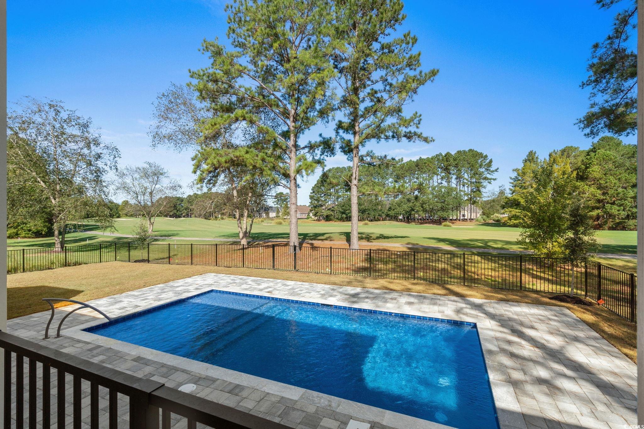 9282 Checkerberry Square Calabash, NC 28467 - Photo 30 of 40 View of swimming pool with a patio, golf course view, and a fenced backyard