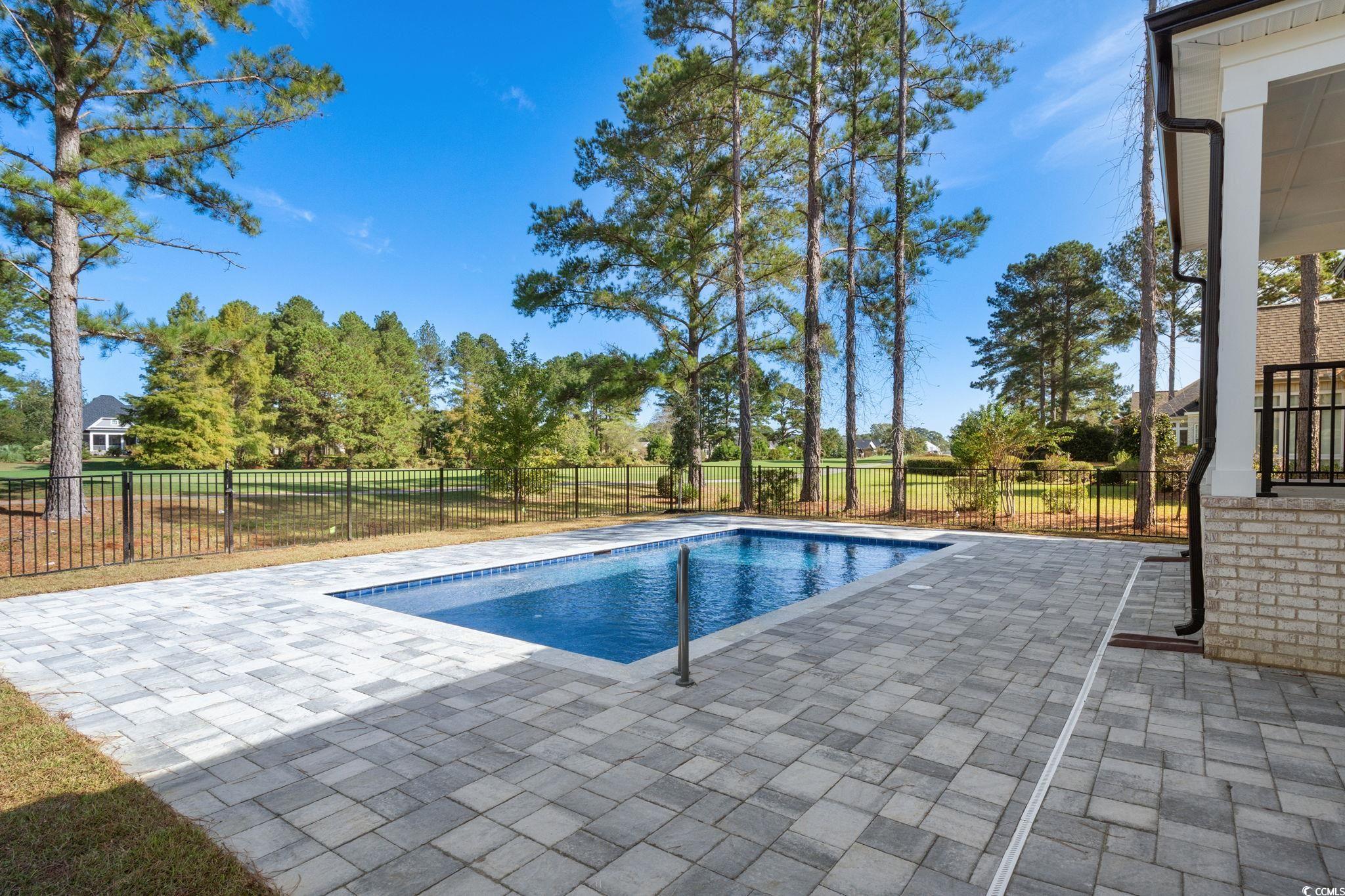 9282 Checkerberry Square Calabash, NC 28467 - Photo 31 of 40 View of pool with a patio and a fenced backyard