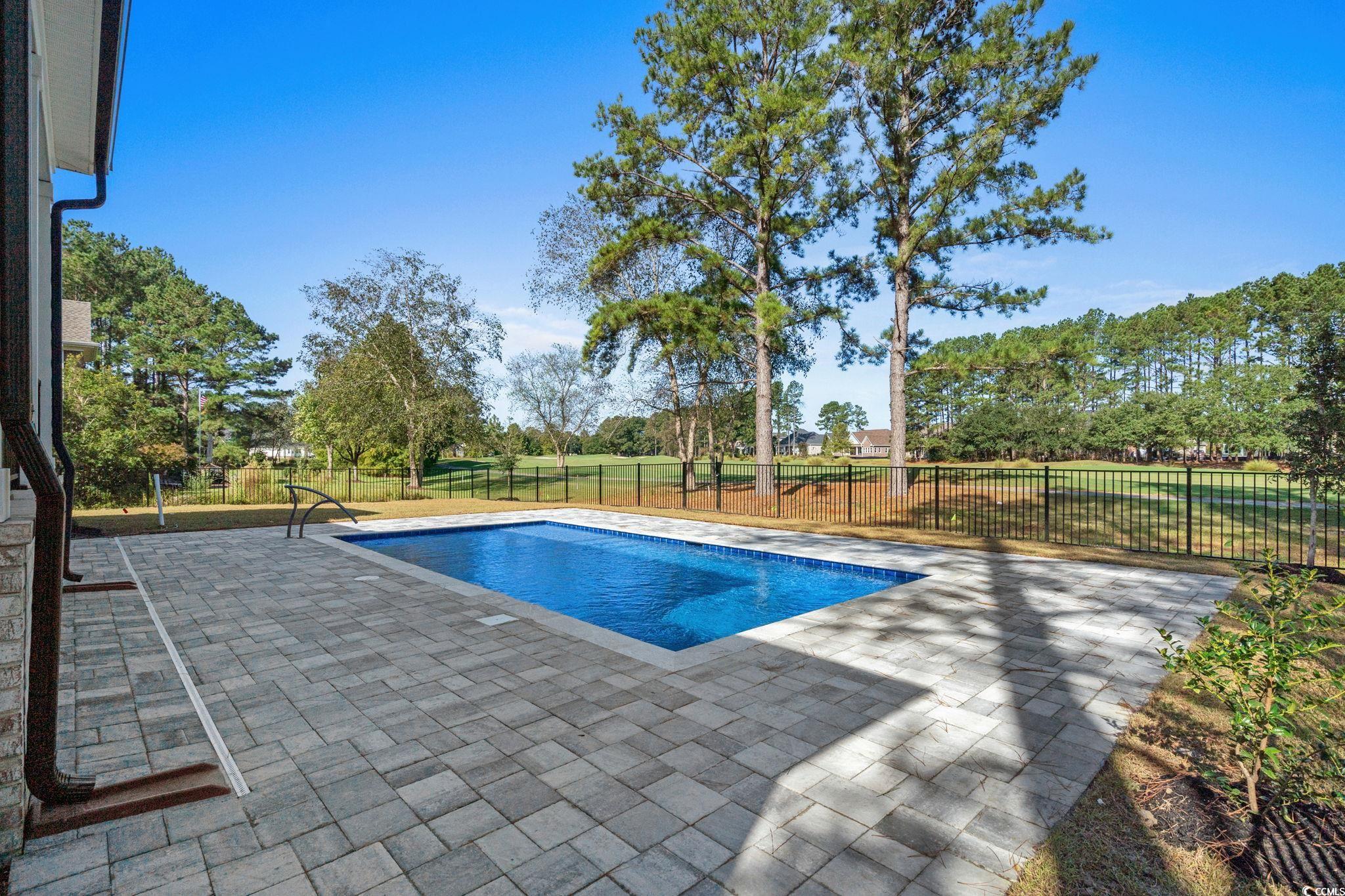 9282 Checkerberry Square Calabash, NC 28467 - Photo 32 of 40 View of swimming pool featuring a patio area and a fenced backyard
