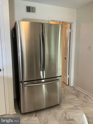 a view of a refrigerator in kitchen and stainless steel appliances