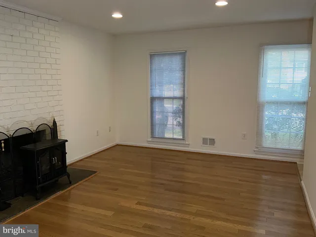 a view of a livingroom with wooden floor and a window