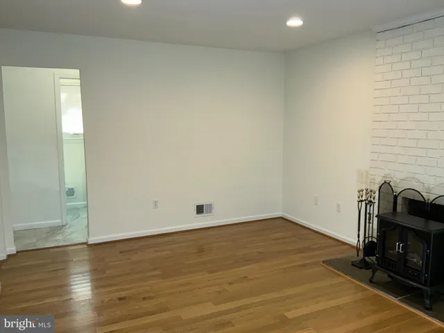 a view of a room with wooden floor and a sink