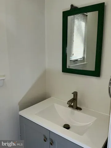 a bathroom with a sink a mirror and vanity