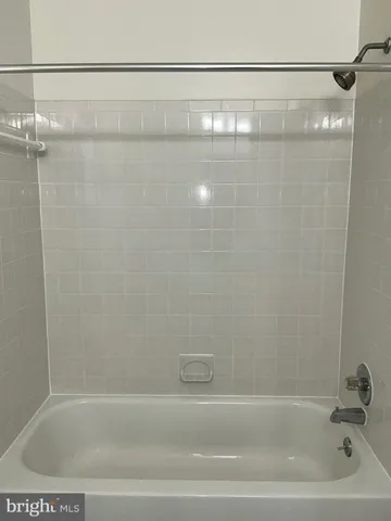 a bathroom with a shower and a bath tub
