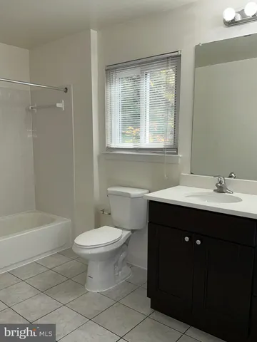 a bathroom with a sink toilet a mirror and a bathtub