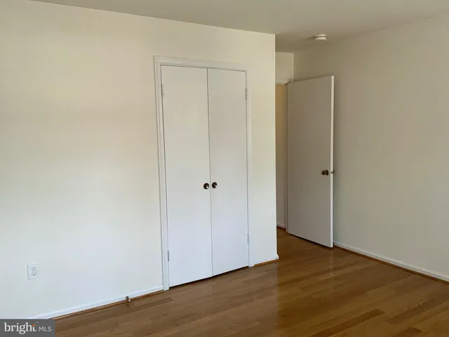 an empty room with wooden floor