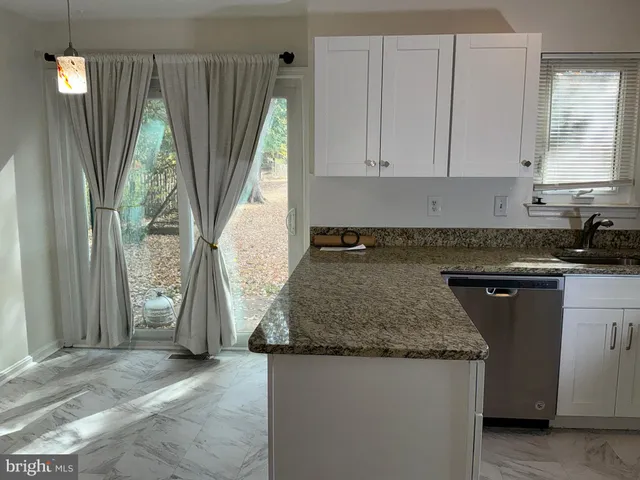 a kitchen with a sink a counter top space and cabinets