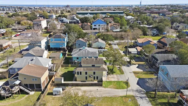 an aerial view of residential houses with yard