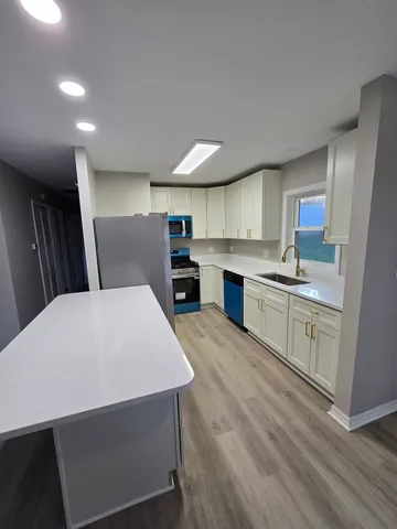 a kitchen with stainless steel appliances a microwave sink and cabinets