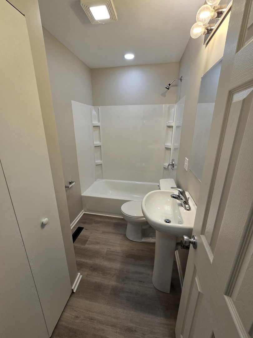 60 South Seebert Street Cary, IL 60013 - Photo 8 of 14 a bathroom with a sink a toilet a mirror and shower