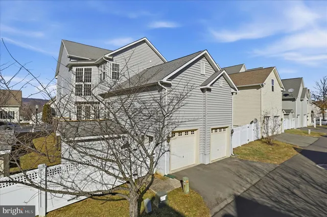 a view of a house with wooden fence