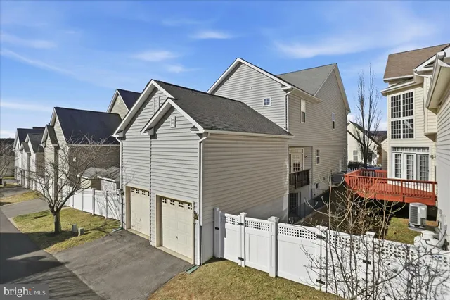 a view of a house with wooden fence