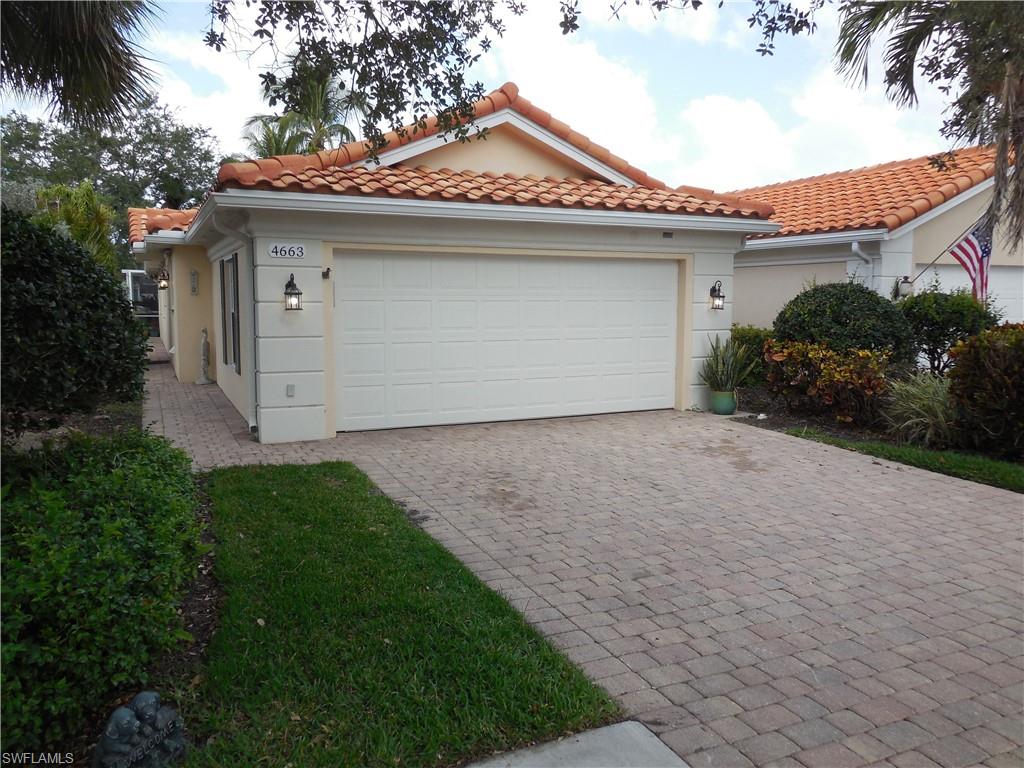 4663 Ossabaw Way Naples, FL 34119 - Photo 1 of 44 View of front facade featuring an attached garage, decorative driveway, stucco siding, and a tile roof