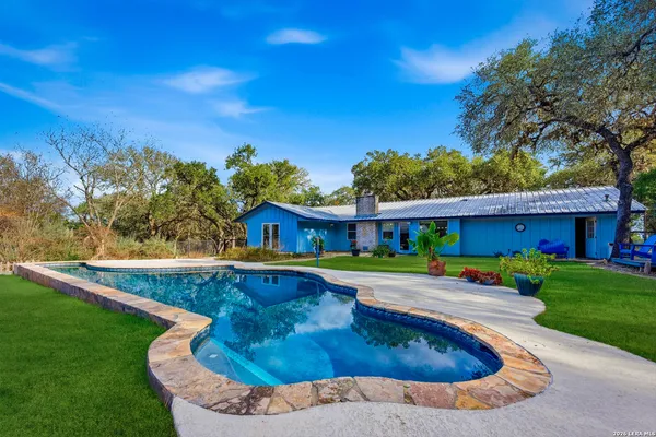 a swimming pool with outdoor seating and yard