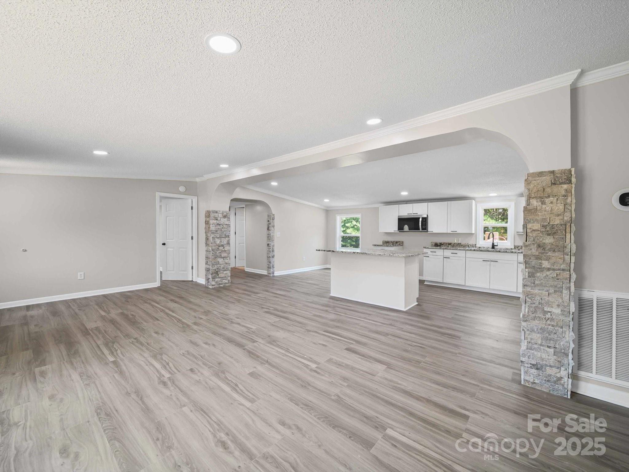 147 Xienghone Road Mount Gilead, NC 27306 - Photo 12 of 22 a view of a kitchen with wooden floor and windows
