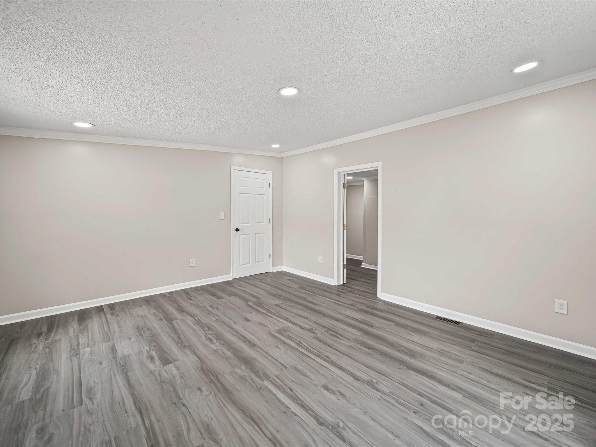 147 Xienghone Road Mount Gilead, NC 27306 - Photo 16 of 22 a view of an empty room with wooden floor and closet