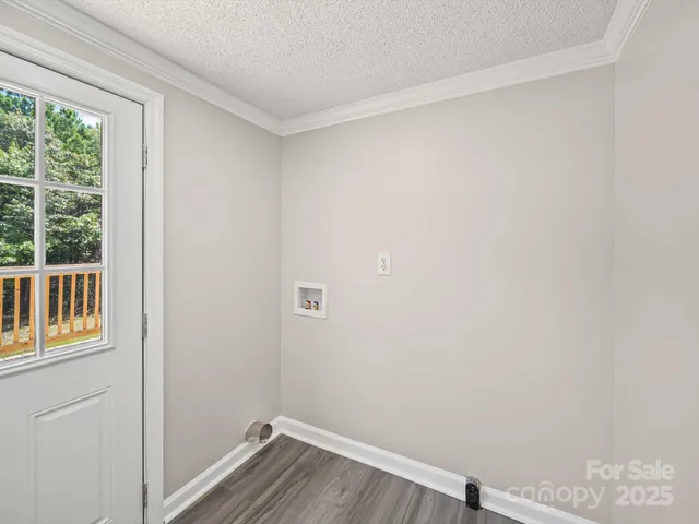 a view of a small space with wooden floor and a window