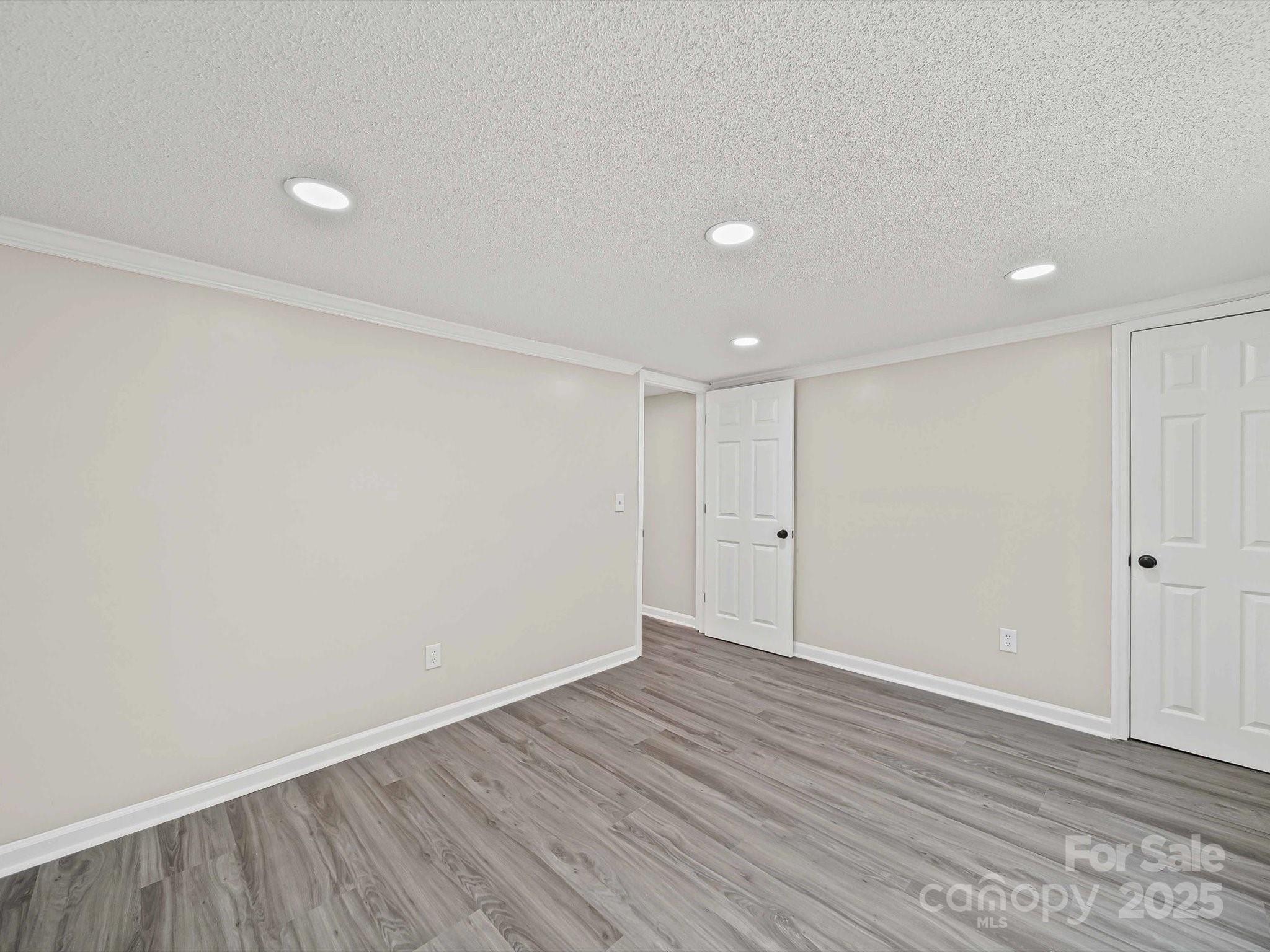 147 Xienghone Road Mount Gilead, NC 27306 - Photo 19 of 22 a view of an empty room with wooden floor