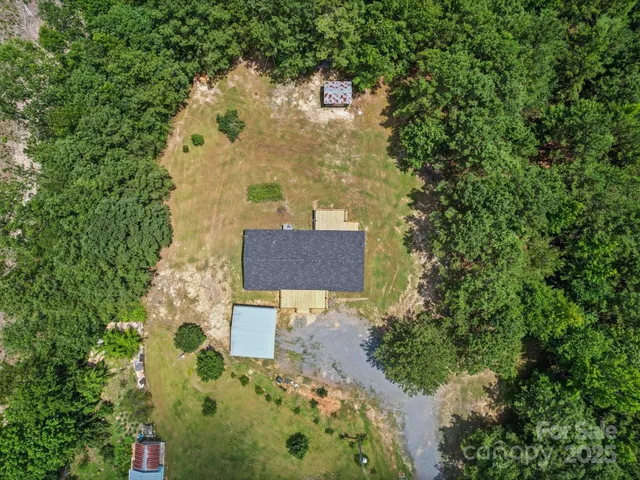 an aerial view of a house with outdoor space