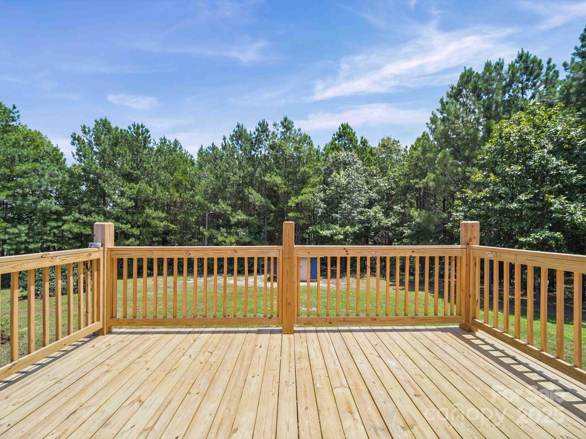147 Xienghone Road Mount Gilead, NC 27306 - Photo 5 of 22 a view of deck with wooden floor and fence with a barbeque