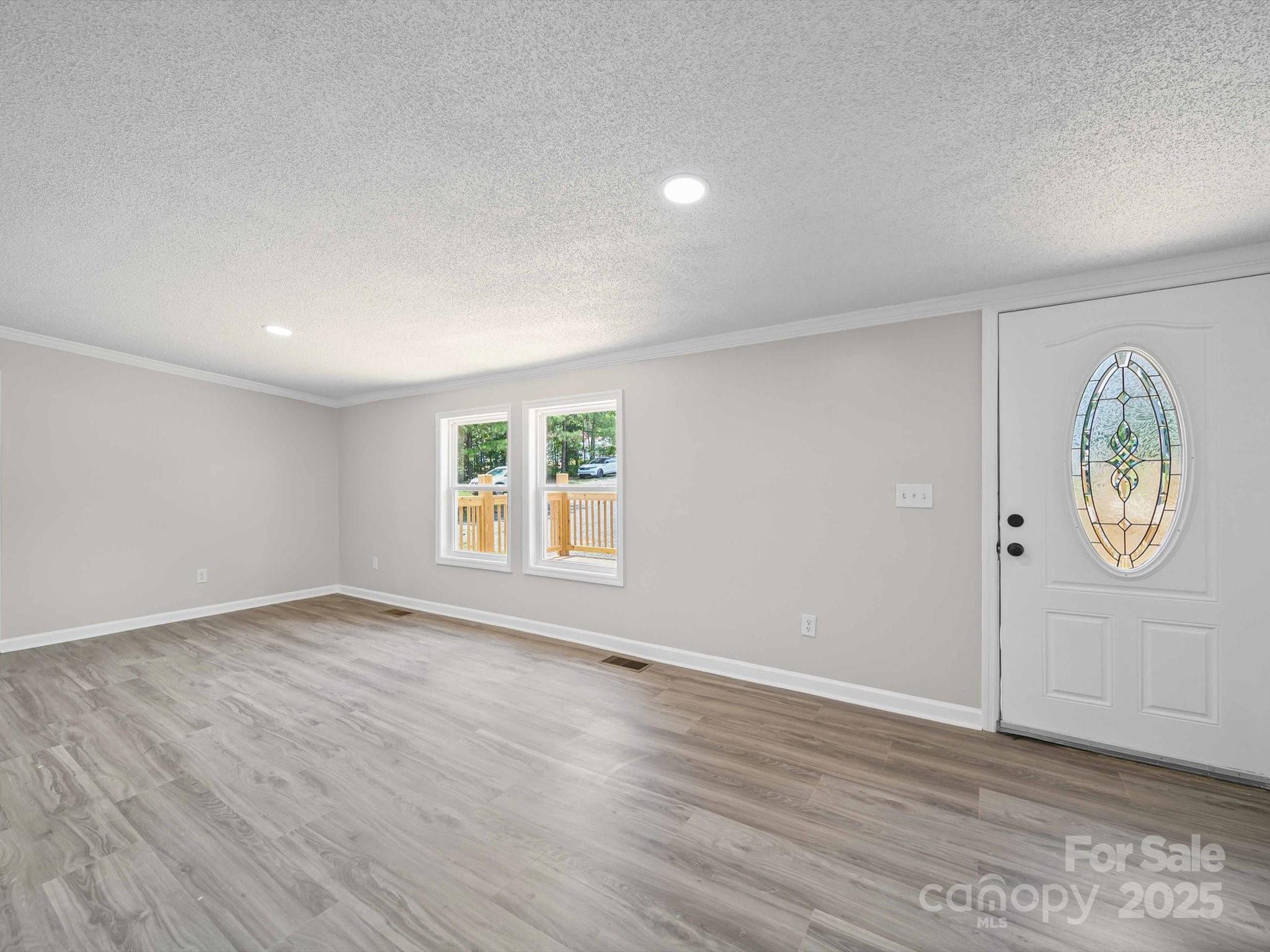 147 Xienghone Road Mount Gilead, NC 27306 - Photo 9 of 22 an empty room with wooden floor and window