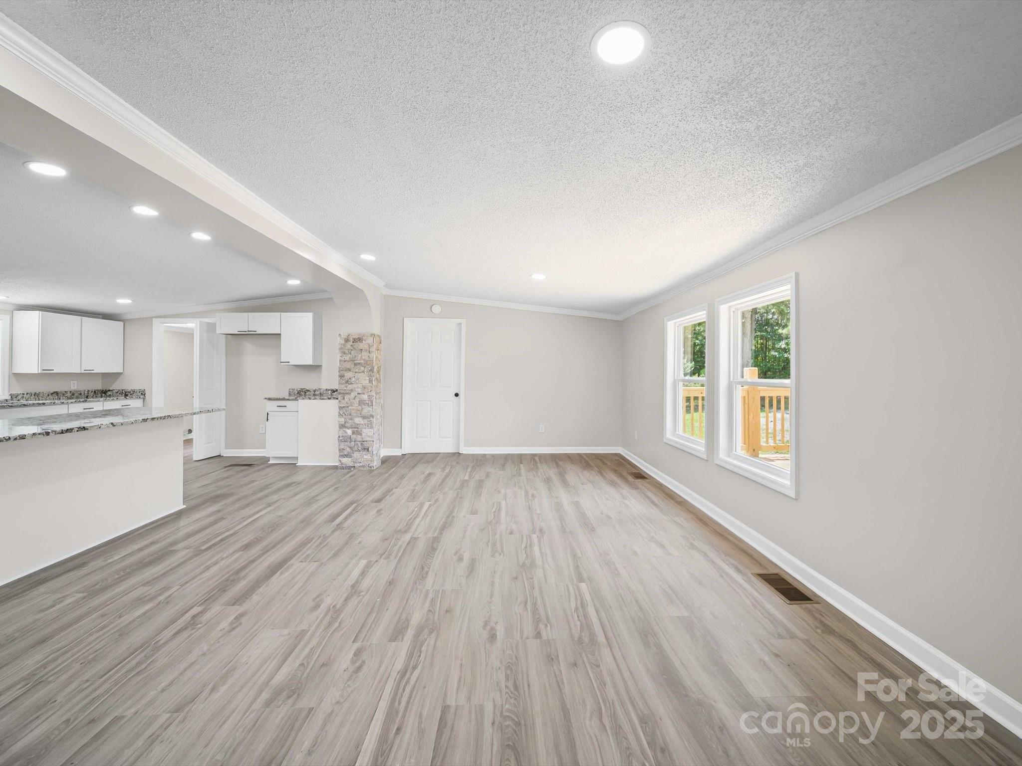 147 Xienghone Road Mount Gilead, NC 27306 - Photo 10 of 22 a view of a kitchen with wooden floor and a window